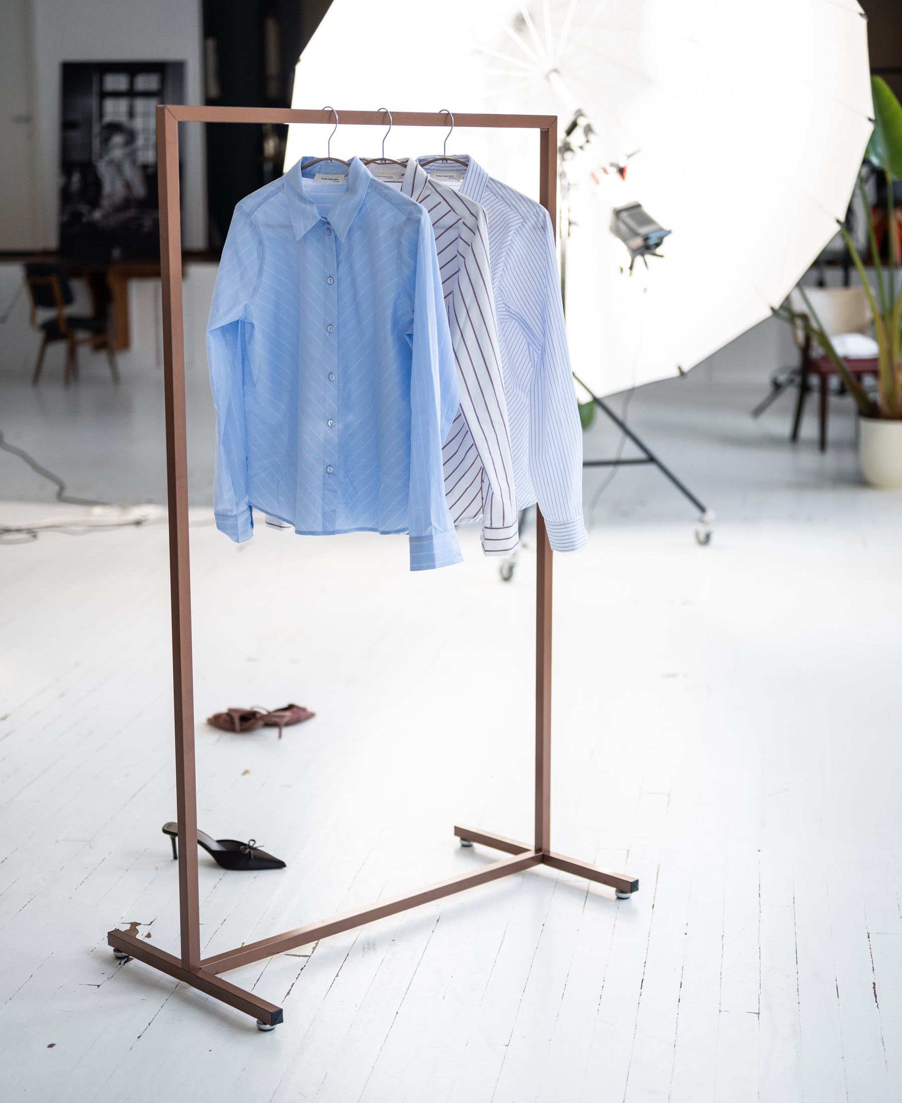 The Striped Shirt LA LOIRE White/Light Blue from PLEIN PUBLIQUE hangs on the rack.