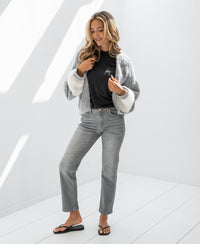 Grey stonewash cropped jeans called "Le Guy" displayed in a bright room.