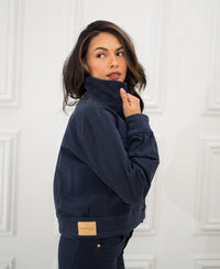 Dark blue stretch denim jacket, collar up, rear view.