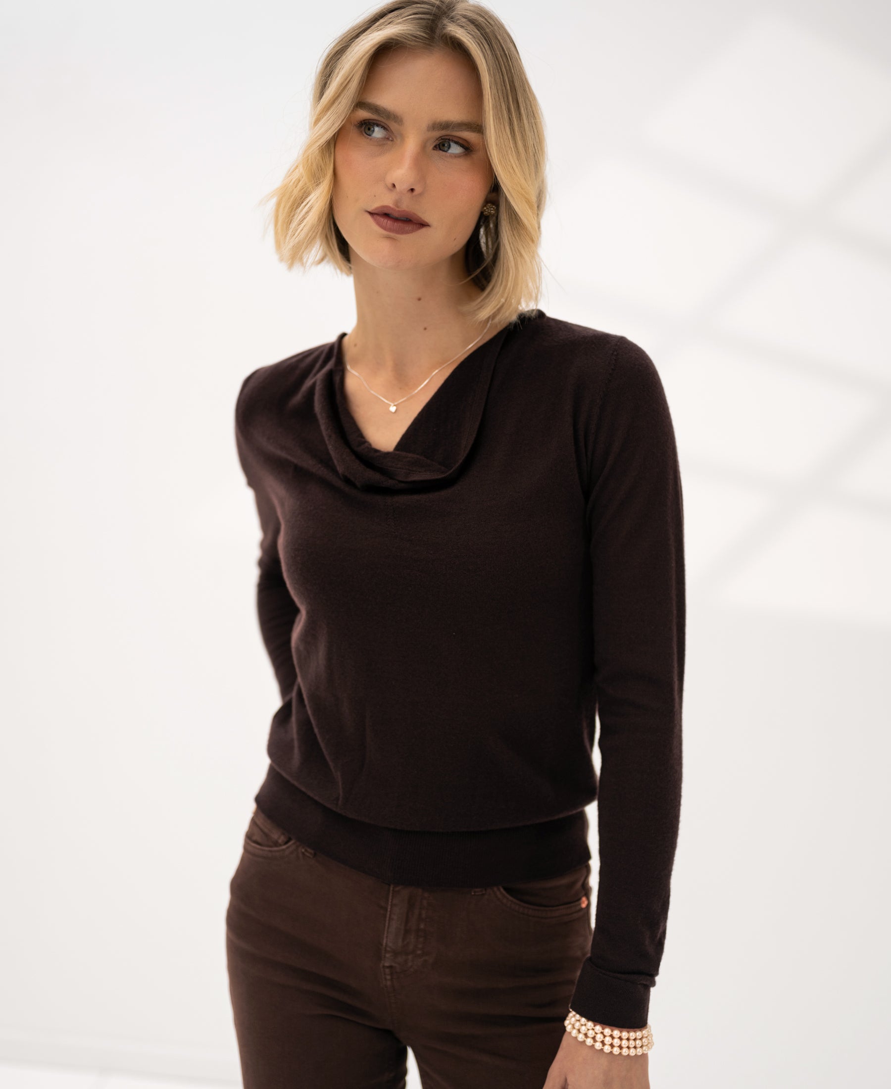 Chocolate brown waterfall neck sweater, front view, shown in a bright minimalist space.
