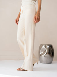 Cream wide-leg LE CENTRE trousers by PLEIN PUBLIQUE.
