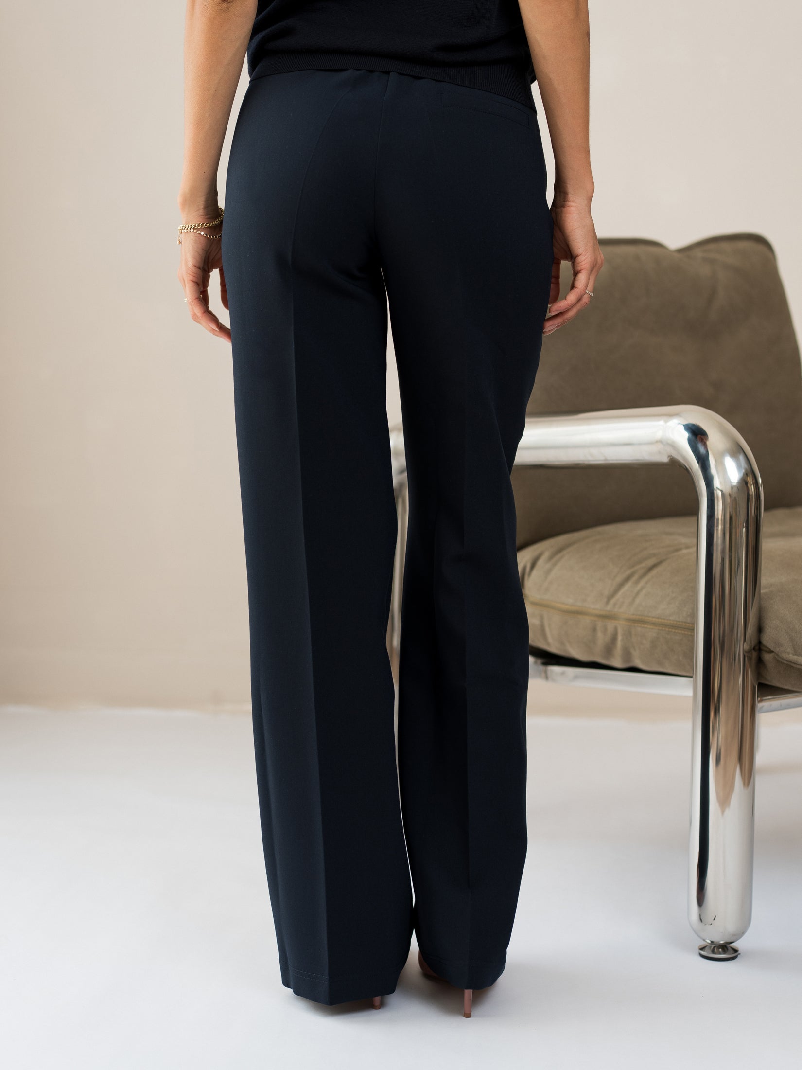 Back view of person wearing PLEIN PUBLIQUE LE CENTRE Dark Blue Trousers.