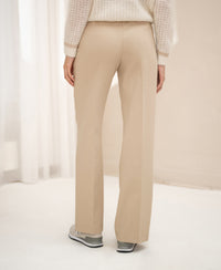 Back view of wide-leg light sand pants.