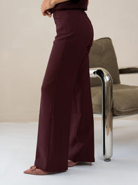 Wide-leg Bordeaux trousers in a modern setting.