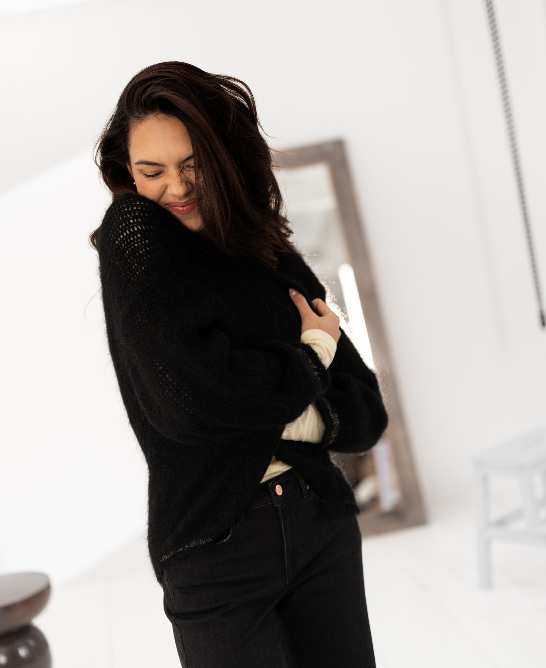 Black fluffy vest by PLEIN PUBLIQUE, LA CHERIE, shown on model with long dark hair.