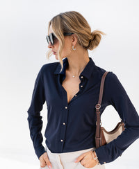Dark blue Plein Publique La Cherise travel blouse with matte gold buttons.