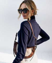 Woman wearing dark blue PLEIN PUBLIQUE LA CHERISE travel blouse.