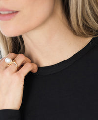 Woman wearing the PLEIN PUBLIQUE Luxe undershirt LE CHOLET Black, touching her collar.
