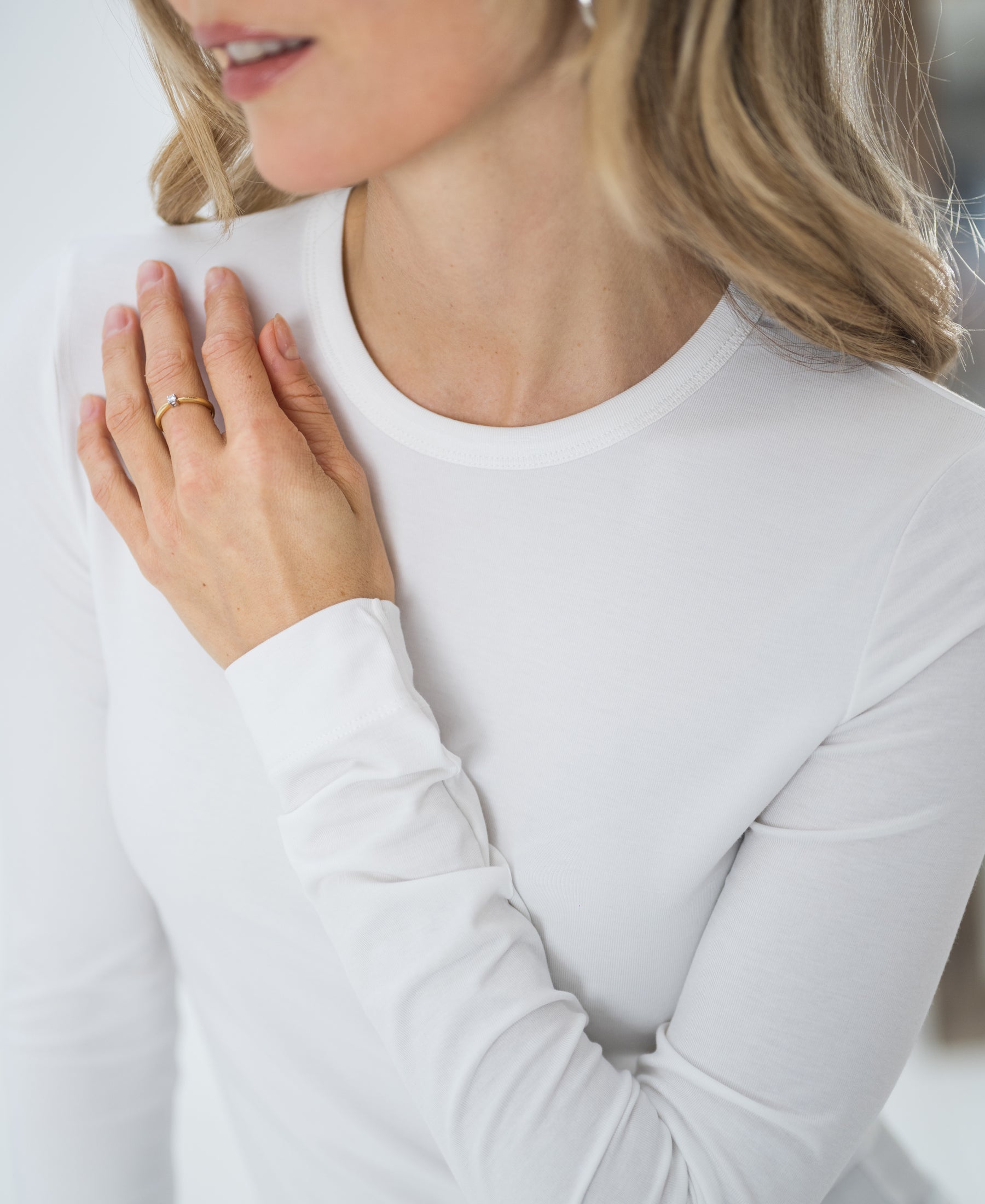 Woman wears the PLEIN PUBLIQUE Luxe undershirt LE CHOLET White.