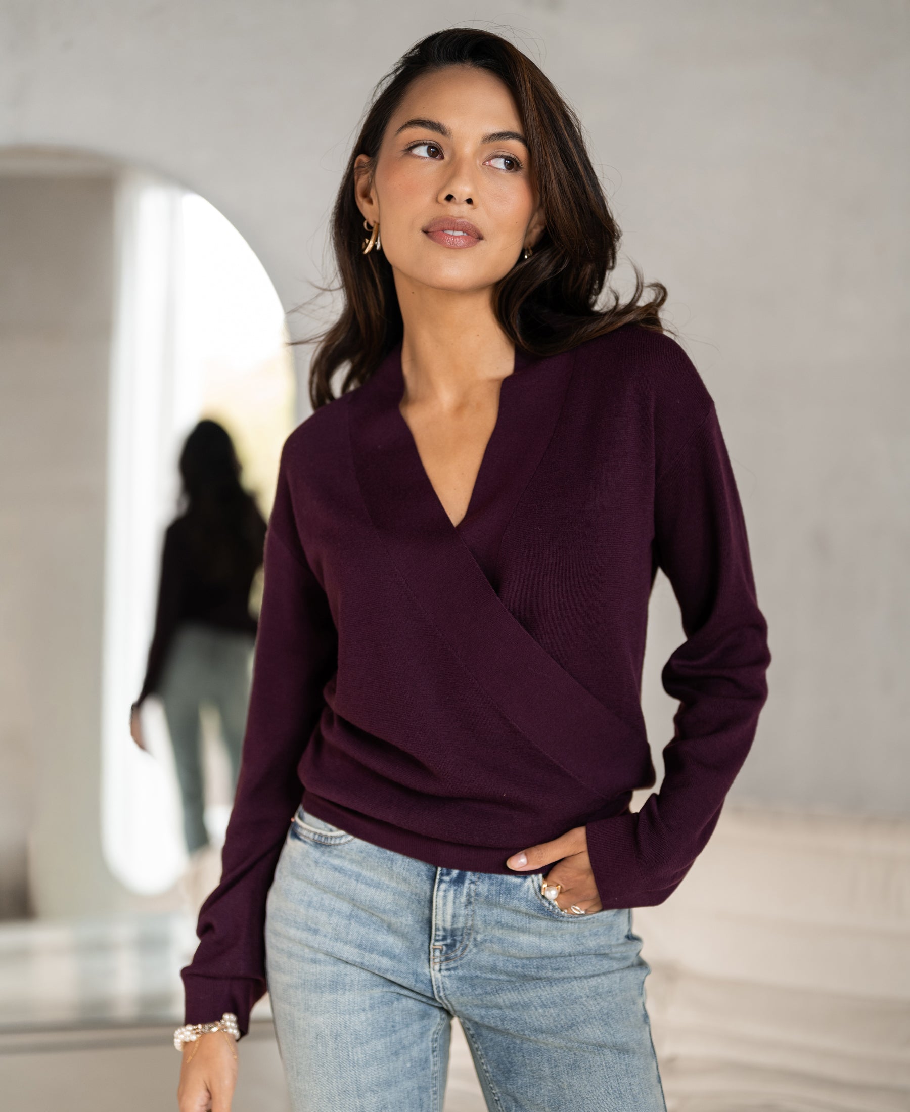 Aubergine wrap sweater by PLEIN PUBLIQUE, style LES CINQ, shown indoors with a mirrored view from behind.