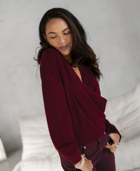 Dark red wrap sweater from PLEIN PUBLIQUE, LES CINQ collection, shown indoors.