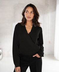 Black PLEIN PUBLIQUE wrap sweater LES CINQ, shown indoors, side view.