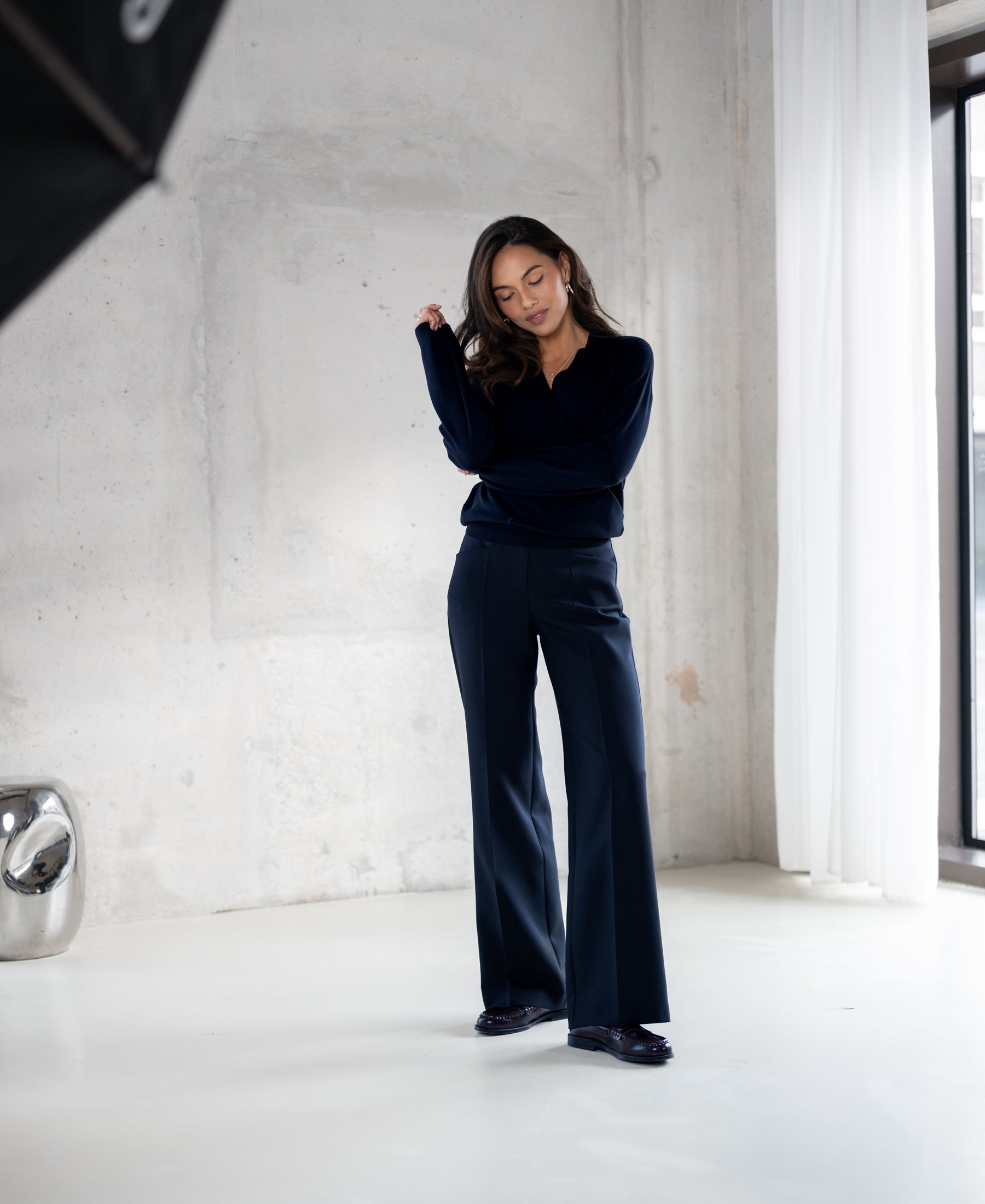 Navy blue wrap sweater from PLEIN PUBLIQUE shown worn by a model, front view.