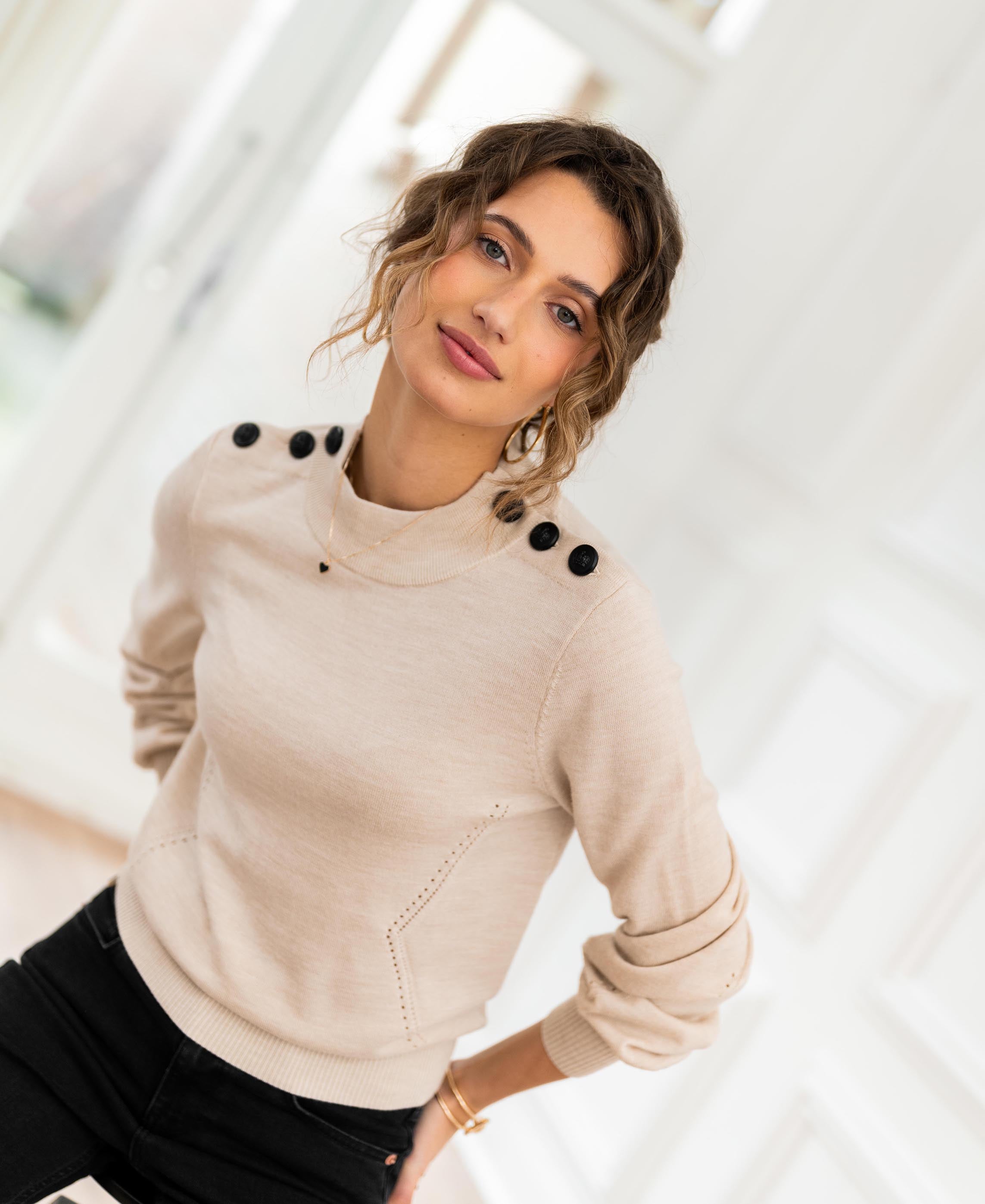 Woman wearing PLEIN PUBLIQUE Merino sweater LA CLIQUE in light sand color.