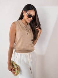 Sleeveless polo sweater in soft camel, woman smiling.