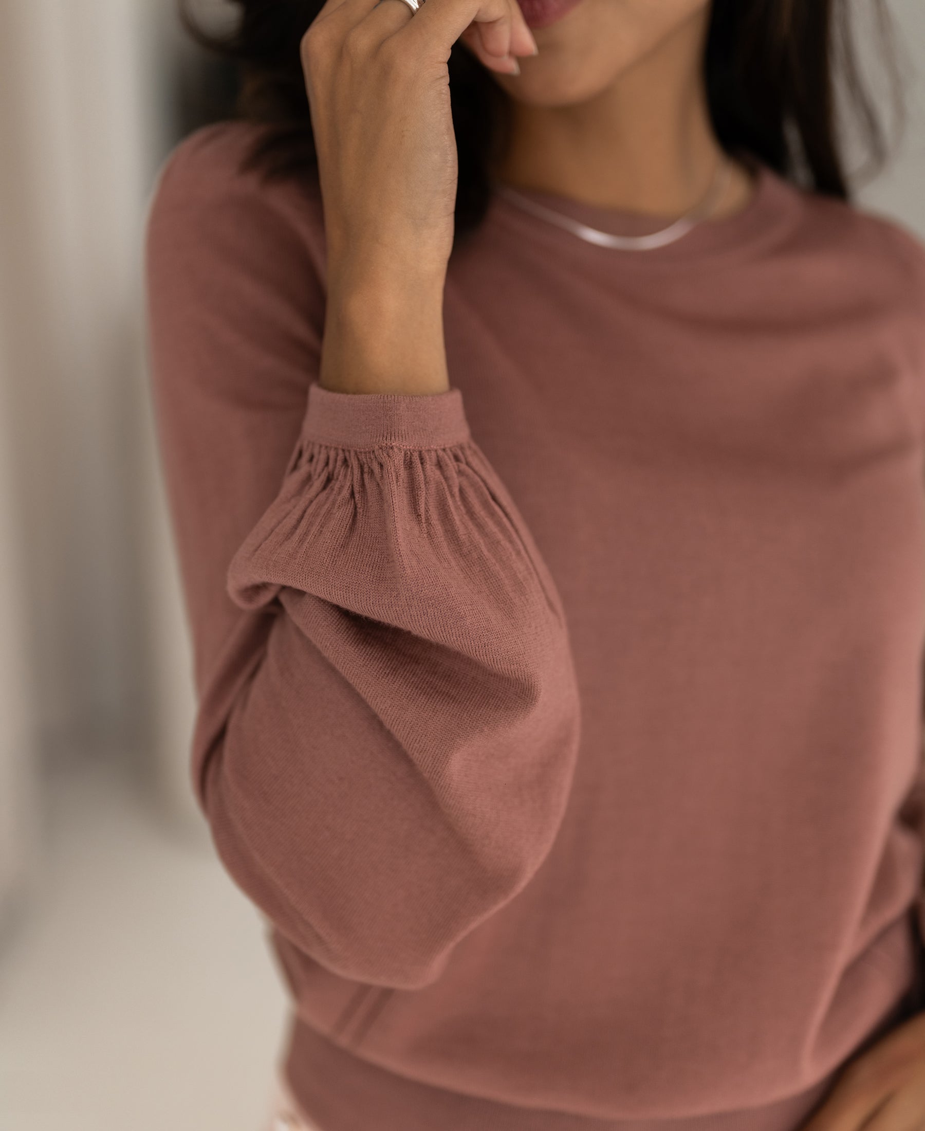 Dusty pink merino wool sweater with gathered balloon sleeves.