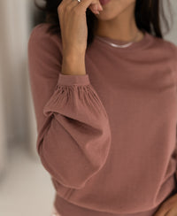 Dusty pink merino wool sweater with gathered balloon sleeves.