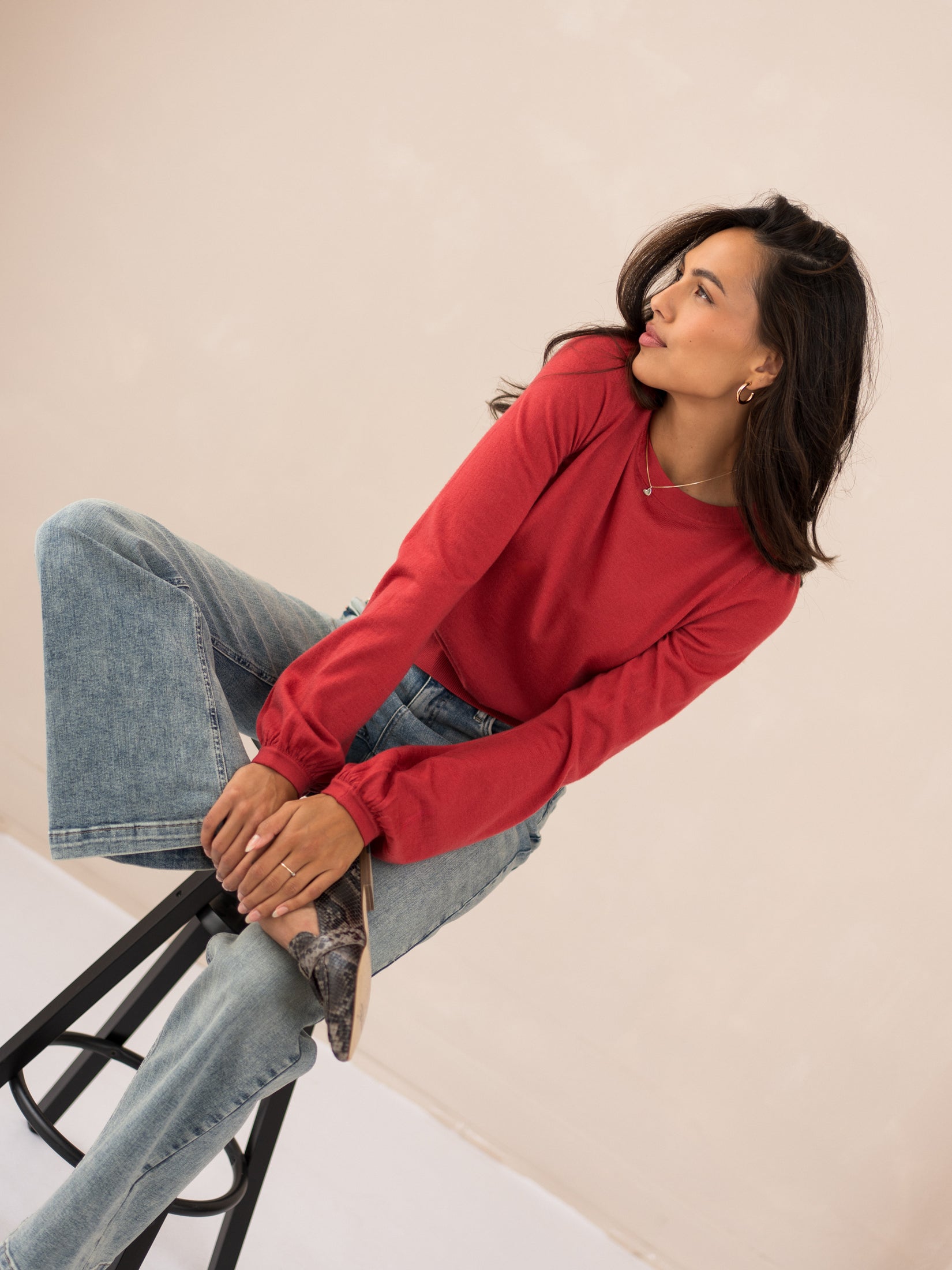 Red merino wool LA COEUR Rouge sweater by PLEIN PUBLIQUE, shown from the side.
