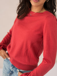 Red merino wool sweater LA COEUR by PLEIN PUBLIQUE, shown on model against a light background.