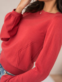 Red merino wool sweater with ajour detail, shown shoulders to waist.