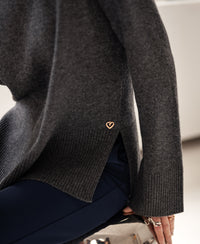 Charcoal turtleneck sweater with gold heart detail.