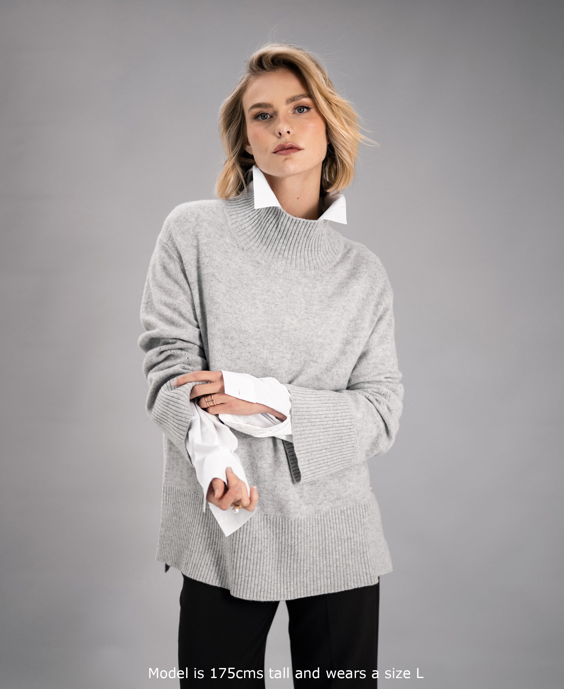 Grey turtleneck sweater by PLEIN PUBLIQUE, shown on a woman against a plain background.