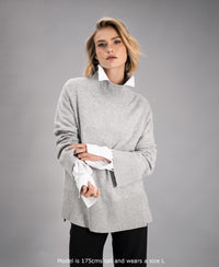 Grey turtleneck sweater by PLEIN PUBLIQUE, shown on a woman against a plain background.