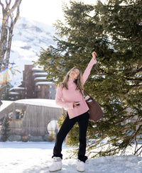 Woman wears a pink LA COZY turtleneck sweater by PLEIN PUBLIQUE.