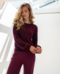 Burgundy LA COEUR sweater by PLEIN PUBLIQUE shown indoors in soft natural light.
