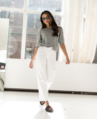 Cropped white jeans by Plein Publique, style Le Dean, shown worn indoors.