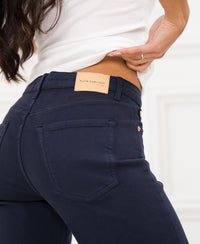 Dark blue jeans by PLEIN PUBLIQUE with garment-dyed leather label visible.