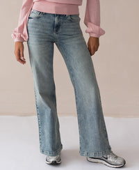 Wide leg jeans in a vintage wash by Plein Publique, shown indoors.