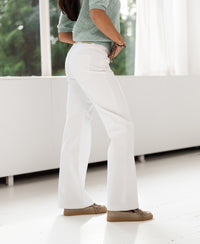 Wide leg jeans in white from PLEIN PUBLIQUE shown worn indoors.