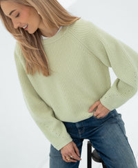 Woman wearing the PLEIN PUBLIQUE LE DIJON light green merino wool sweater.
