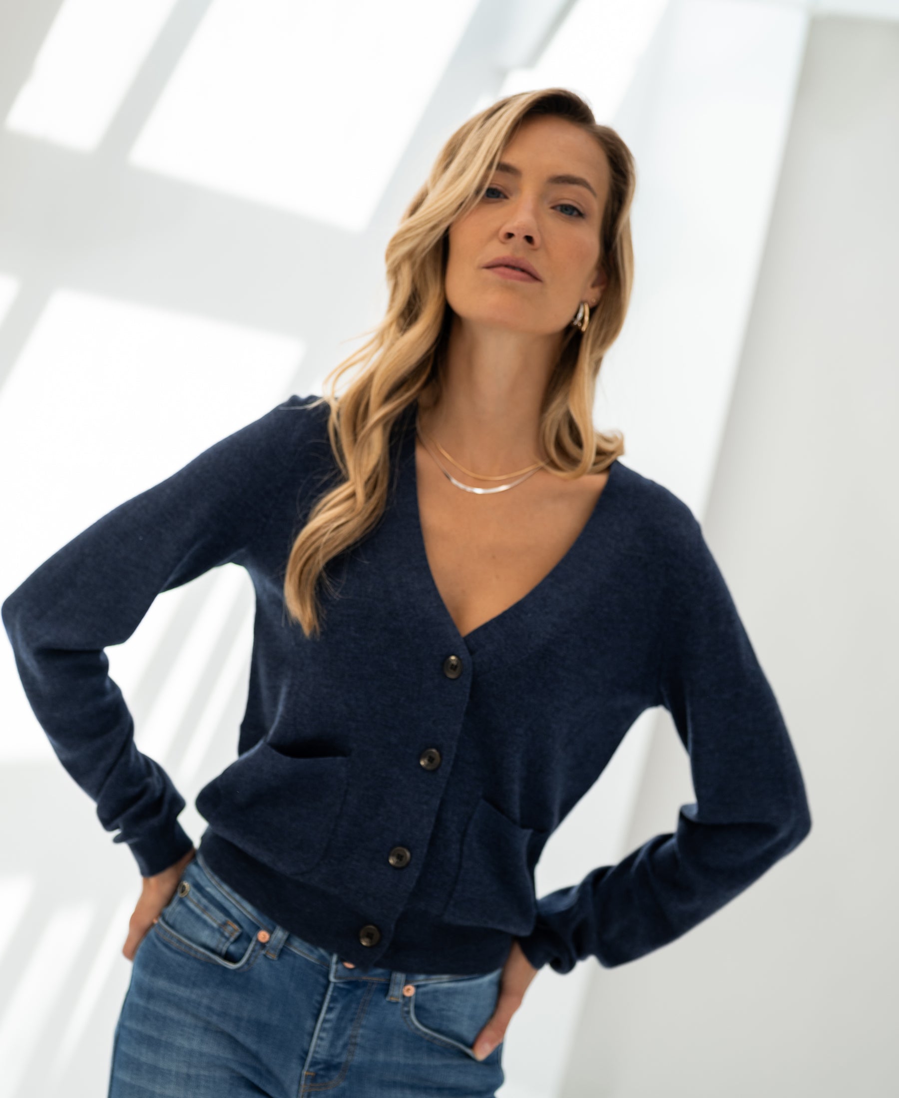 Indigo blue Merino cardigan LA DONNA by PLEIN PUBLIQUE shown in a sunny room.