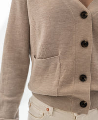 Close-up of the Merino wool vest "The Woman" in sand color by PLEIN PUBLIQUE with black buttons.