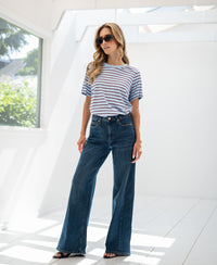 Striped LA DYLAN T-shirt by PLEIN PUBLIQUE in a sunlit white room.