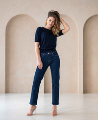 Woman wearing PLEIN PUBLIQUE LE GUY rinse wash cropped jeans, standing in a bright room.