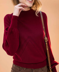 Woman wears the LES SALLES dark red turtleneck sweater by PLEIN PUBLIQUE.