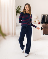 Woman wearing dark blue PLEIN PUBLIQUE knitted trousers.