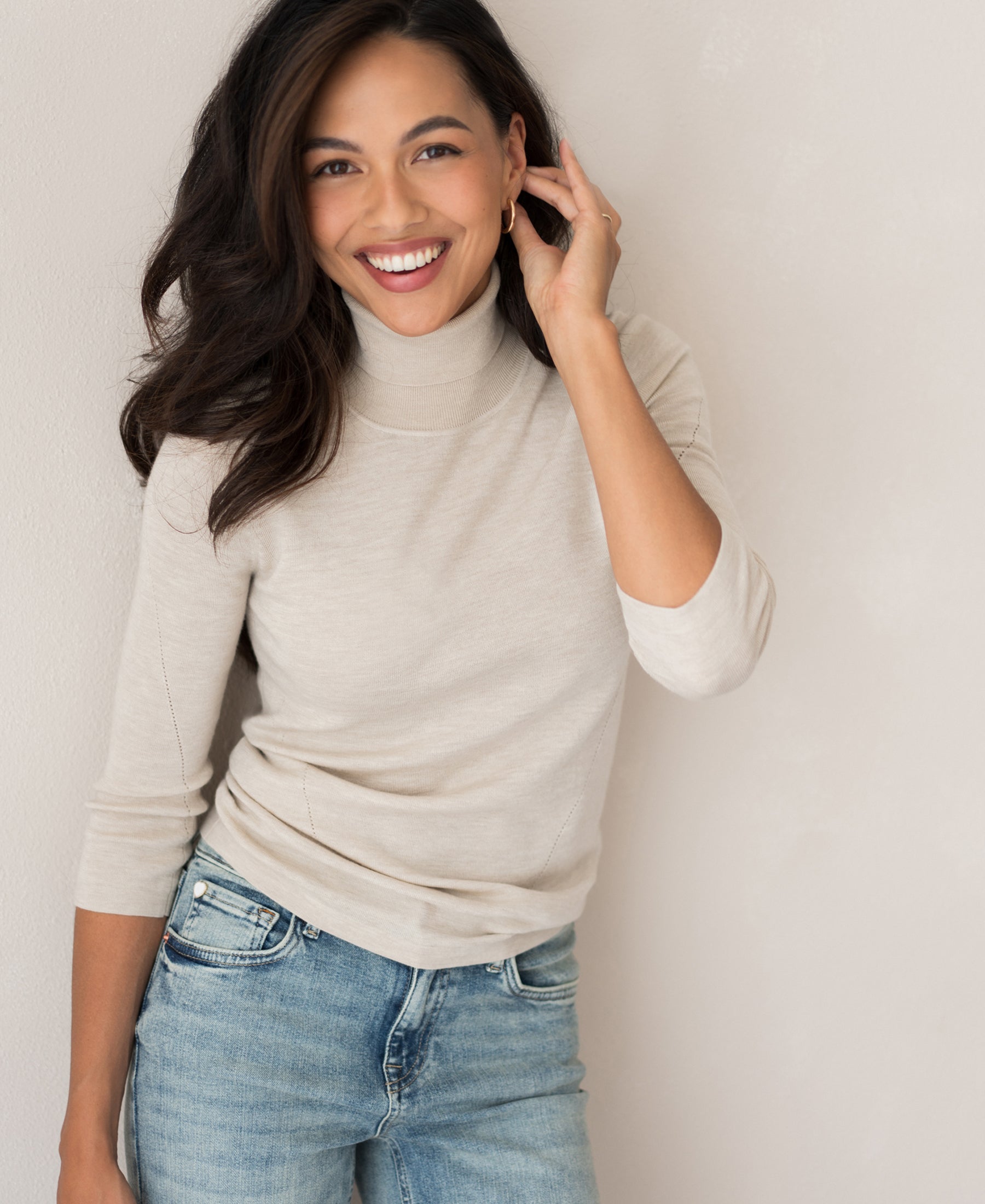 PLEIN PUBLIQUE LE FABIAN beige turtleneck sweater displayed against a light-colored wall.