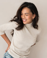 Beige PLEIN PUBLIQUE LE FABIAN turtleneck sweater shown on a model.