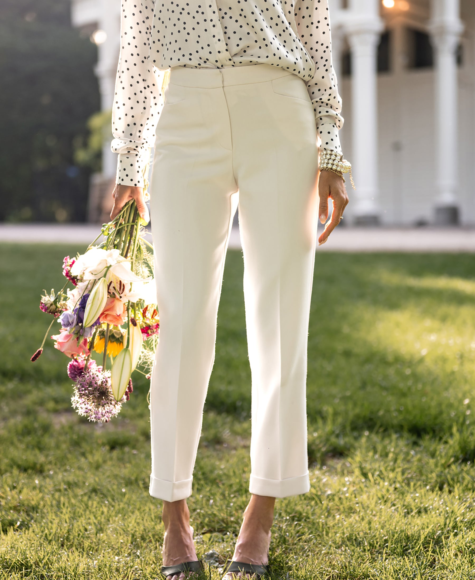 Person wearing cream 7/8-length Faubourg pants by Plein Publique.