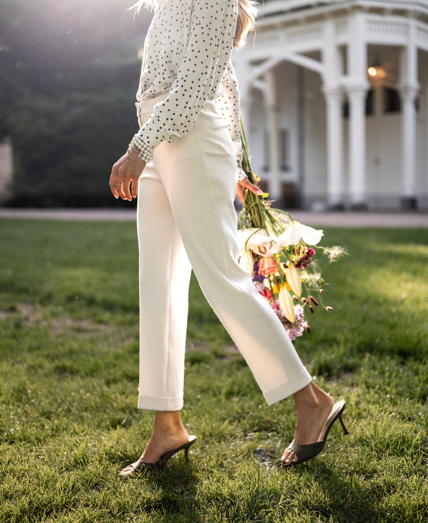 Cream cropped pants worn outdoors.