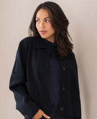 Dark blue wool blazer by Plein Publique, style LA FAYE, shown against a light-colored wall.