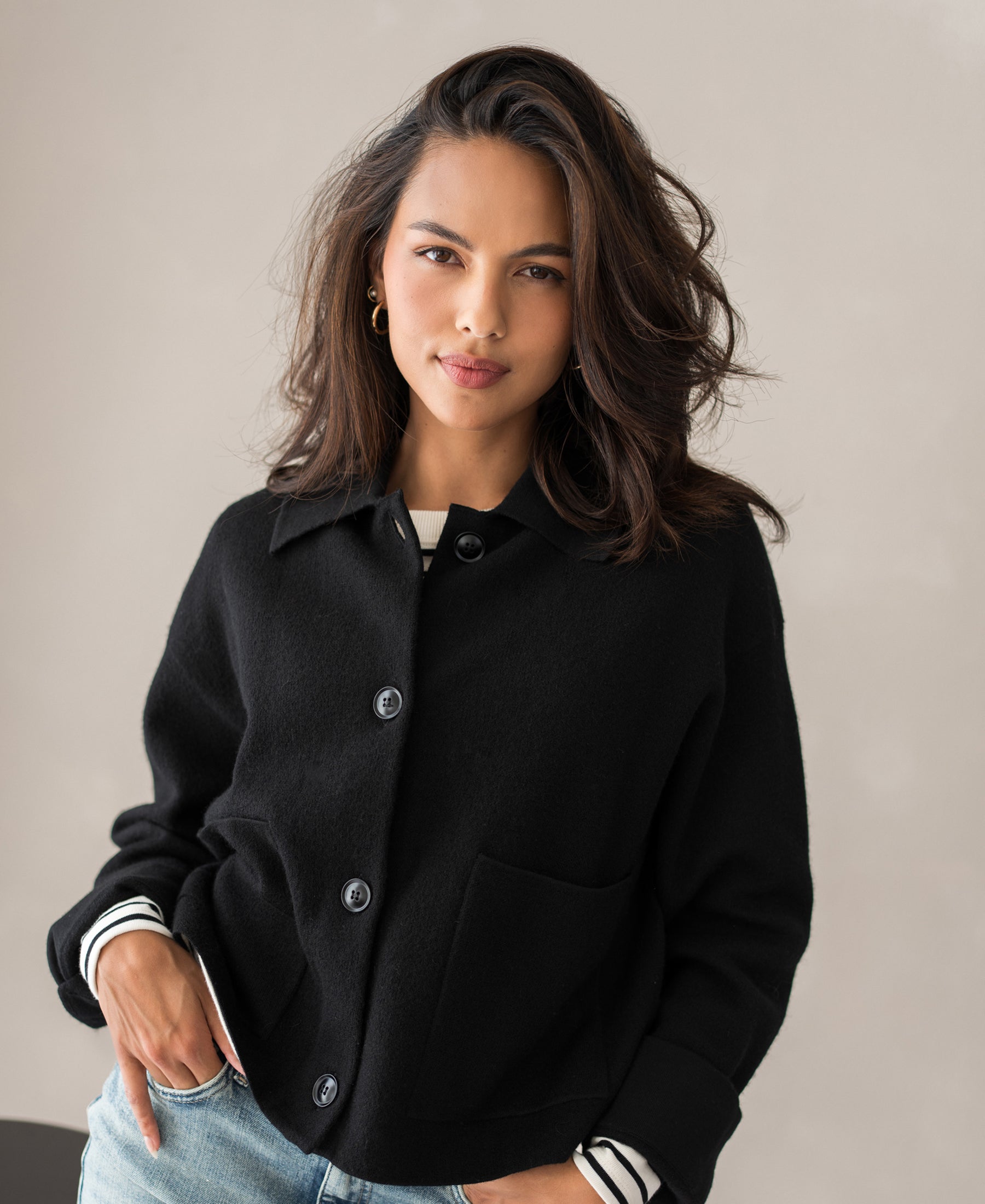 Woman wearing black wool LA FAYE vest jacket with hand in pocket, ideal for in-between seasons.
