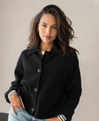 Woman wearing black wool LA FAYE vest jacket with hand in pocket, ideal for in-between seasons.
