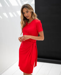 Red button-up dress by PLEIN PUBLIQUE shown in a minimal studio with black and white walls.
