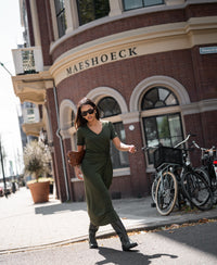 Woman wearing a Plein Publique La Filicia dark olive green long dress.