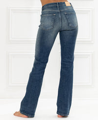 High-waisted blue vintage flared jeans in denim, shown from the back.